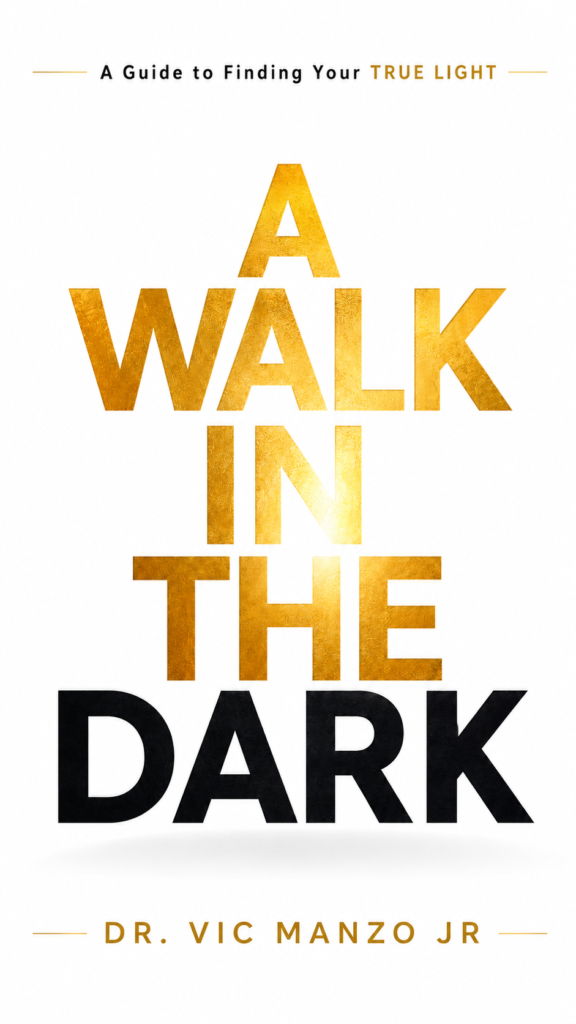 Minimalist book cover for A Walk in the Dark by Dr. Vic Manzo Jr featuring elegant gold and black typography on a clean white background representing transformation, resilience, and personal growth.